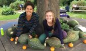 Student interns, Ange Heese and Lydia Beardsley, pose with squash varieties harvested from the OHIO Student Farm.