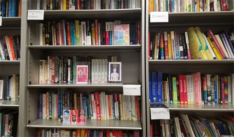 The shelves are lined with books and decorations