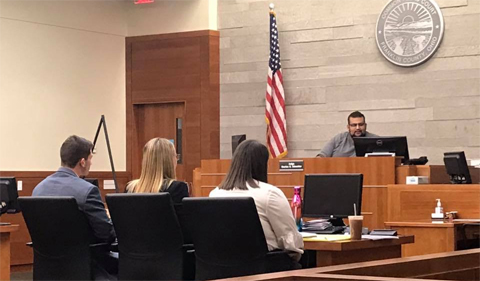Ohio University Plaintiff's Team prepares for trial against Xavier University's Defense, shown in courtroom.