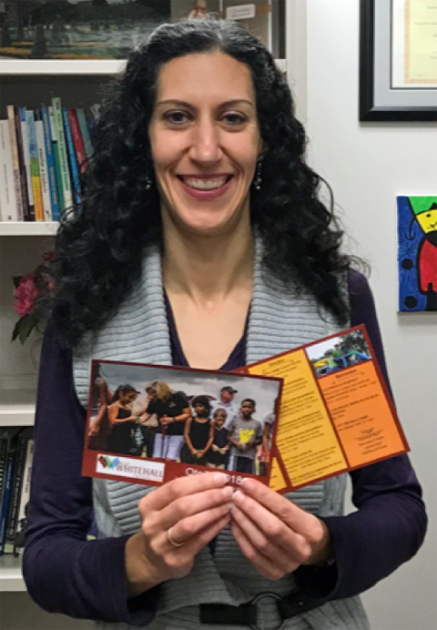 Dr. María Postigo, holding documents she translated from English into Spanish to be shared at the Latino Night in Whitehall, Ohio.