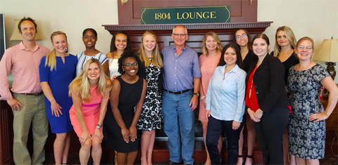 Group of people standing in front of "1804 Lounge" sign in Baker Center.