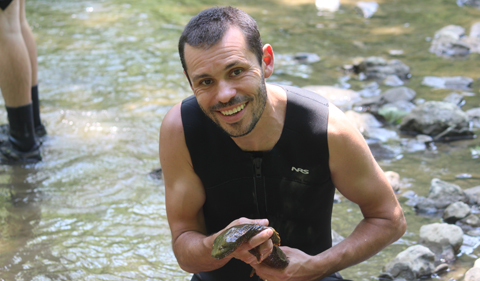 Dr. Viorel Popescu holds a hellbender, a foot-long salamander