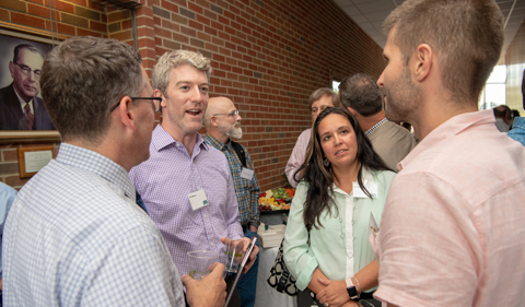 Dr. Kevin King, left, and Dr. Corey Beck, welcome corporate community members Joe Walter and Becky '94.