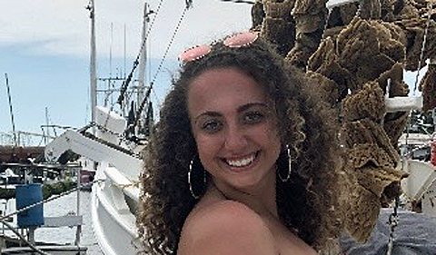 Olivia Gedeon, studying abroad, posing with boats at marina