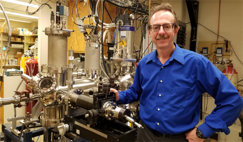 Arthur R. Smith poses in front of his group’s spin- polarized scanning tunneling microscope.