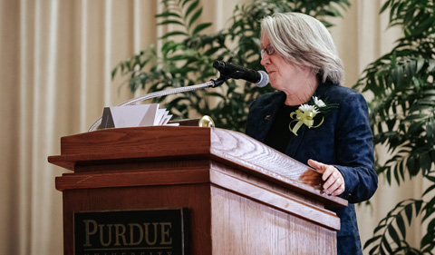 Dr. Sarah Wyatt makes remarks at Purdue, shown here at the lecturn.