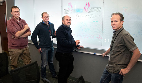 Theoretical calculations performed by (left to right) Neil Robinson, Robert Konik, Alexei Tsvelik, and Andreas Weichselbaum of Brookhaven Lab's Condensed Matter Physics and Materials Science Department suggest that Majorana fermions exist in the boundaries of magnetic materials with different magnetic phases. Majorana fermions are particle-like excitations that emerge when single electrons fractionalize into two halves, and their unique properties are of interest for quantum applications.
