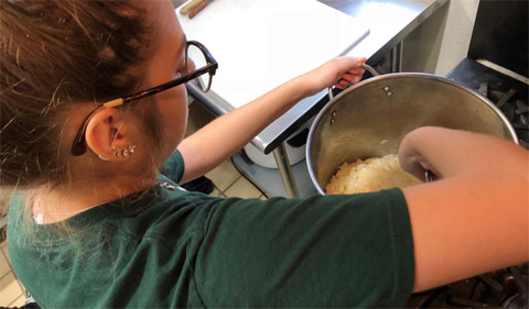 Emily Wilson, President of the Arabic Language Student Association stirs spices for Shakshuka