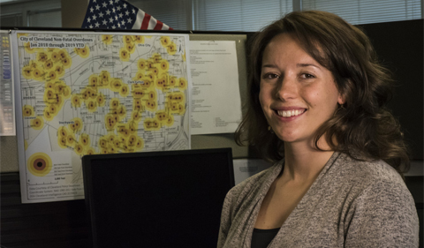 U.S. Air Force Staff Sgt. Carolyn Kinzel, a C-130H Hercules loadmaster assigned to the 179th Airlift Wing, Ohio Air National Guard, and an Ohio Air National Guard Counterdrug Task Force criminal analyst, poses in front of an overdose map she created Aug. 1, 2019, at the Drug Enforcement Administration (DEA), Cleveland, Ohio. The Ohio National Guard Counterdrug Task Force personnel provide support to law enforcement agencies and community based organizations in order to enhance efforts to counter and defeat the threat of illegal substances, trafficking and violence in Ohio. (U.S. Air National Guard photo by Airman 1st Class Alexis Wade)