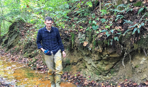 Ryan Wolbert, pictured beside an acid mine drainage site