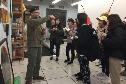 John Sabraw with Iwate students, showing them the paint pigment created out of Tarō dirt in March 2019.