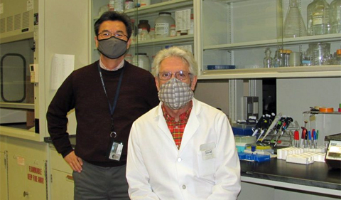 Dr. Daewoo Lee (standing) and Dr. Robert Colvin (seated) in the their lab, where Alzheimer's disease research is conducted.