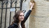Leah Allan touching the owl carved into the Notre Dame de Dijon (a good luck symbol) on the Global Consulting Program (GCP) trip to Dijon France, March 11, 2019.