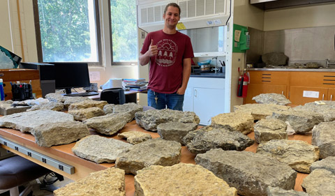 Ian Forsythe with fossils collected in the field displayed back in the lab in Clippinger.