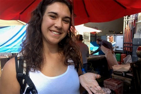 Breanna Oswald holding a tiny starfish at the fish market in Catania, Sicily, 2016