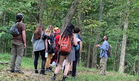 Professor Harvey Ballard leads a nature discussion as students get ready to build trail.